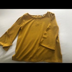 Mustard color shirt , spits in the sleeves,